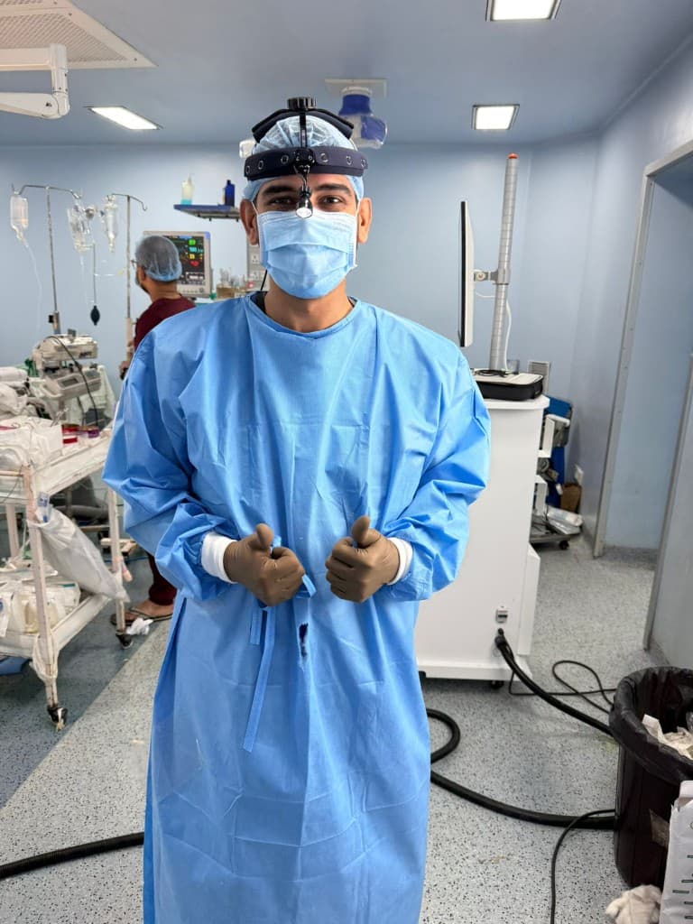 Dr Nikhil Oza in a surgical gown and headlight loupe in the operating theatre